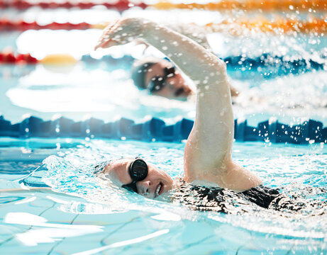 Sports, water splash or people training in swimming pool in a race competition, exercise or cardio workout. Swimmer, fast or athletes with energy or speed in fitness performance or practice challenge