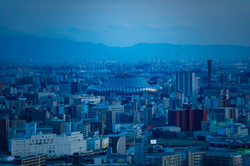 A dusk cityscape by high angle view near Kyocera dome in Osaka telephoto shot