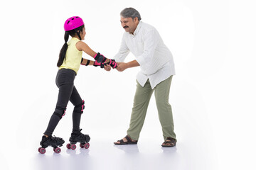 Father helping little daughter skating on roller skating  isolated on white background.