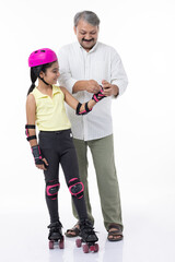 Father helping little daughter skating on roller skating  isolated on white background.