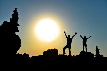 The success of the team reaching the top goal together and the magnificent sunrise view