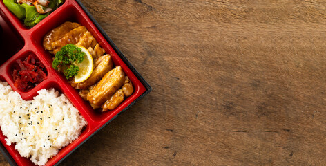 Top view Japanese food bento box set with tonkatsu and tempura, Rice Salad and Main Course....