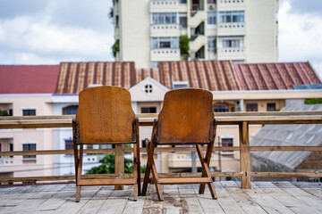Wooden deck at rooftop city with Adirondack chairs