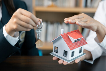Banks approve loans to buy homes. Real estate agents explain the document for customers who come to...