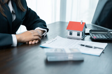 Banks approve loans to buy homes. Real estate agents explain the document for customers who come to...