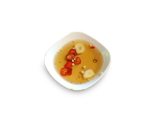A small bowl with fish sauce and chili