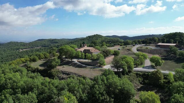 Aerial footage of a chapel and cementery in the middle of the forest.