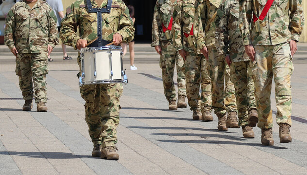 Soldiers marching in a row outdoor