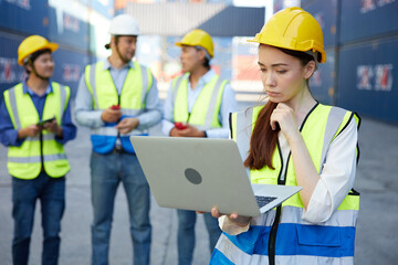factory worker or engineer working on laptop computer in containers warehouse storage