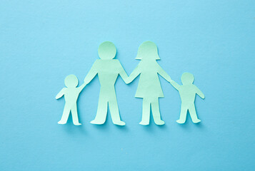 Paper cutout of family (father, mother, son and daughter). Life insurance concept.