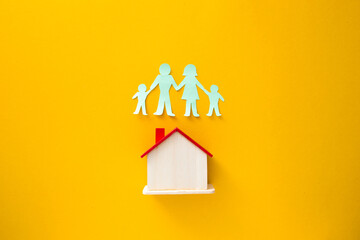 Paper cutout of family (father, mother, son and daughter). Life insurance concept.