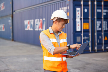 factory worker or engineer working on laptop computer in containers warehouse storage