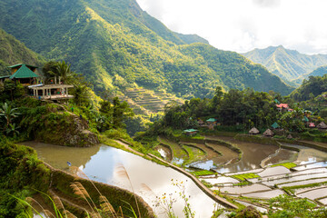 People walking up the stairs to the house surrounded by Ifugao Rice Terraces