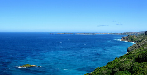 High angle view of coastline and hills calm sea