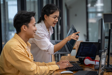 IT programmers, specialists, men and women. Innovative software engineers work on desktop computers developing apps, programs, video games, terminals with coding languages.