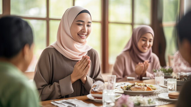 Asian Muslim beautiful woman family making iftar dua to break fasting during Ramadan