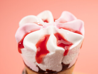 Strawberry ice cream in waffle cups. Ice cream on a pink background.