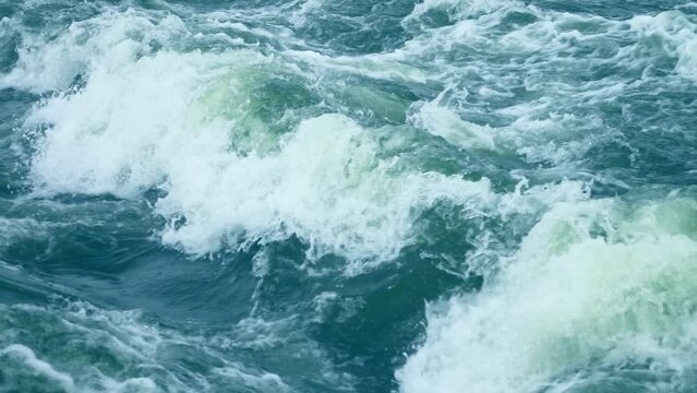 Beautiful natural sea breaking waves. Turquoise water splashing, slow motion, view, scene, side, wavy, wave, tide, splash, flow, spray, wet, fresh, surf, day, static shot, close up, hd. ProRes 422 HQ.
