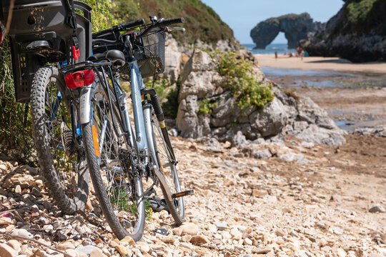Bicycles parked next to a wild beach