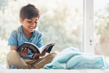 Boy, child and reading book in bedroom for learning, language development or studying literacy. Happy young kid relax with books for storytelling, hobby and knowledge of literature, education and fun