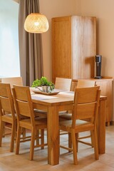 Solid wood kitchen furniture. Table and chairs, cozy home interior.