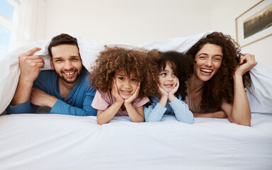 Bedroom portrait, happy family kids and parents smile, bond and relax wellness, home comfort or enjoy morning together. Youth, face and interracial children, mother and father rest on bed mattress