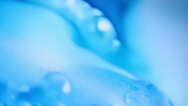A vibrant blue slushie glides across the frame in extreme closeup its texture and colors revealed in all its glory.