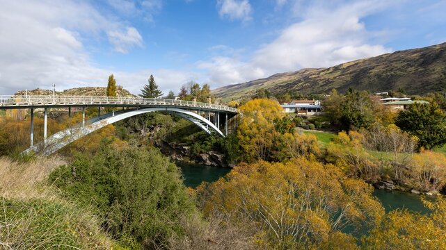 Beautiful autumn trees surrounding Roxburgh Bridge and Clutha River, South Island, New Zealand. 
