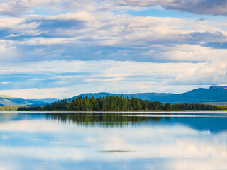 Tranquil nature scene: lake, trees, reflection, Sweden.