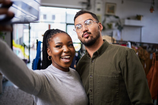 Couple, bond and selfie of people in clothing store for profile picture, social media and blog on internet. Diversity, man and happy black woman take photo in shop for connection and fun memory