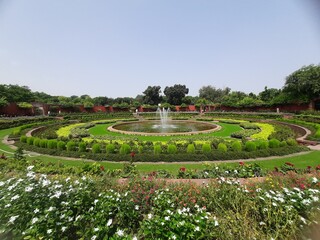 Beautiful garden in the park with fountain 