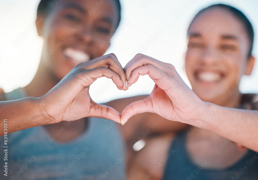 Wall mural Friends, fitness and closeup, women with heart hands and emoji, wellness and health, support and love sign outdoor. Happiness, care and exercise, cardio and sports, healthy and workout together