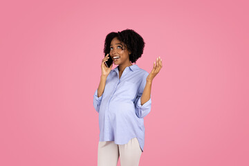 Cheerful young black pregnant woman in casual with belly, call by smartphone