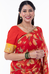 Portrait of smiling woman in traditional Indian sari isolated on white background