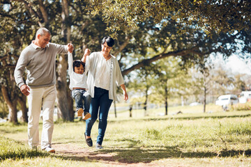 Happy, holding hands and grandparents with child in park for playing, love and support. Swing,...