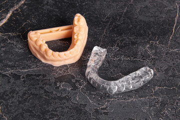 Aligners for teeth alignment and plastic jaw model. Polycarbonate mouth guard. Lower jaw. Removable orthodontic device