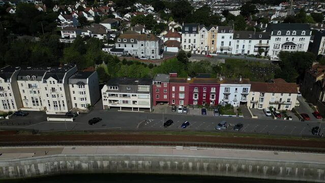 Dawlish, South Devon, England: DRONE VIEWS: Marine Parade houses and properties, the modern, concrete, sea wall defence barrier and railway line. Dawlish is a popular UK holiday resort.