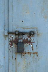 Padlock on metall door. Metal background	