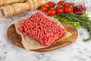 Raw minced beef meat on cutting board