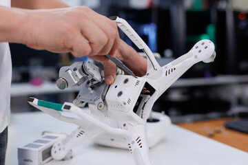 Workshop for the repair of electronic drones. A broken aircraft is being repaired by a specialist. Quadrocopter