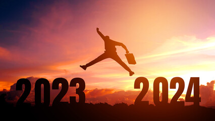 Silhouette young Business man happy to 2024 new year success concept.