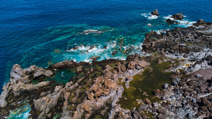 A view over the water of the Atlantic Ocean in Tenerife Island Spain volcanic rocks