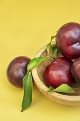 A bamboo wooden bowl filled with ripe
