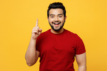 Young insighted smart proactive happy Indian man he wears red t-shirt casual clothes holding index...
