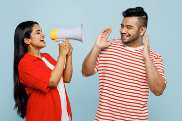 Young fun couple two friends family Indian man woman wear red casual clothes t-shirt together hold...