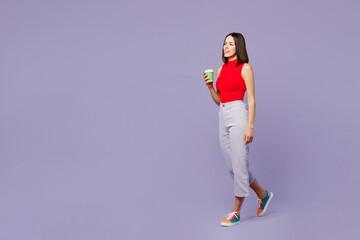 Fototapeta na wymiar Full body young woman wears red tank shirt casual clothes hold takeaway delivery craft paper brown cup coffee to go isolated on plain pastel light purple background studio portrait. Lifestyle concept.
