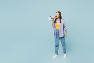 Full body young happy woman she wears purple shirt yellow t-shirt casual clothes hold in hand megaphone scream announces discounts sale Hurry up isolated on plain pastel light blue background studio.