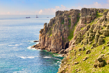 Fototapeta na wymiar The rugged Coast of Cornwall near Land's End and the Longships Lighthouse.