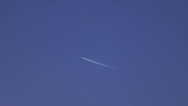 4K Video of chemtrail of airplane going through the sky leaving marks