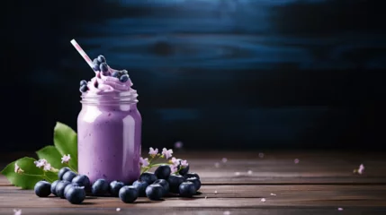 Fototapeten Blueberry smoothie in a glass jar on a wooden background. © Darya